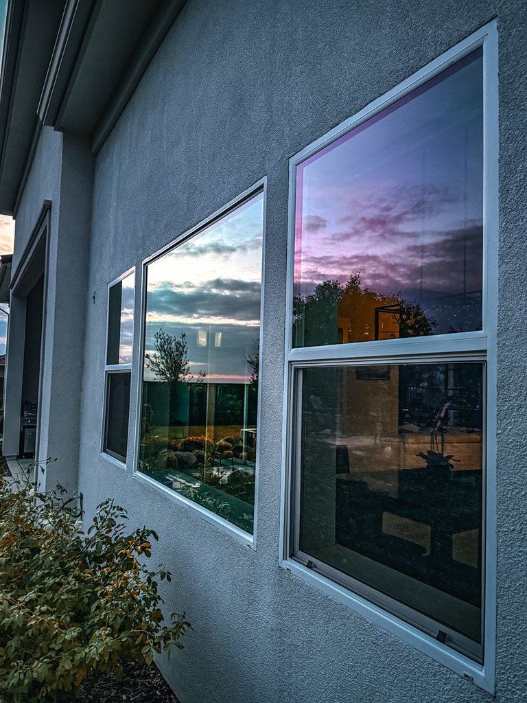 Streak-free residential windows reflecting dusk sky after Supreme Clean cleaning